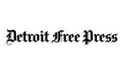 The image shows the Detroit Free Press logo in blackletter font, with bold, ornate lettering on a white background.